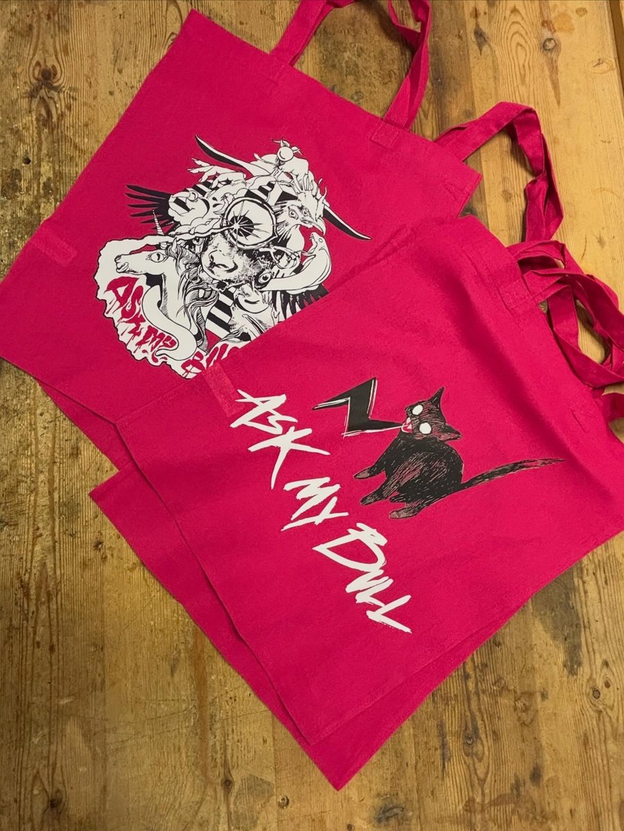 Bright pink Ask My Bull tote bags
